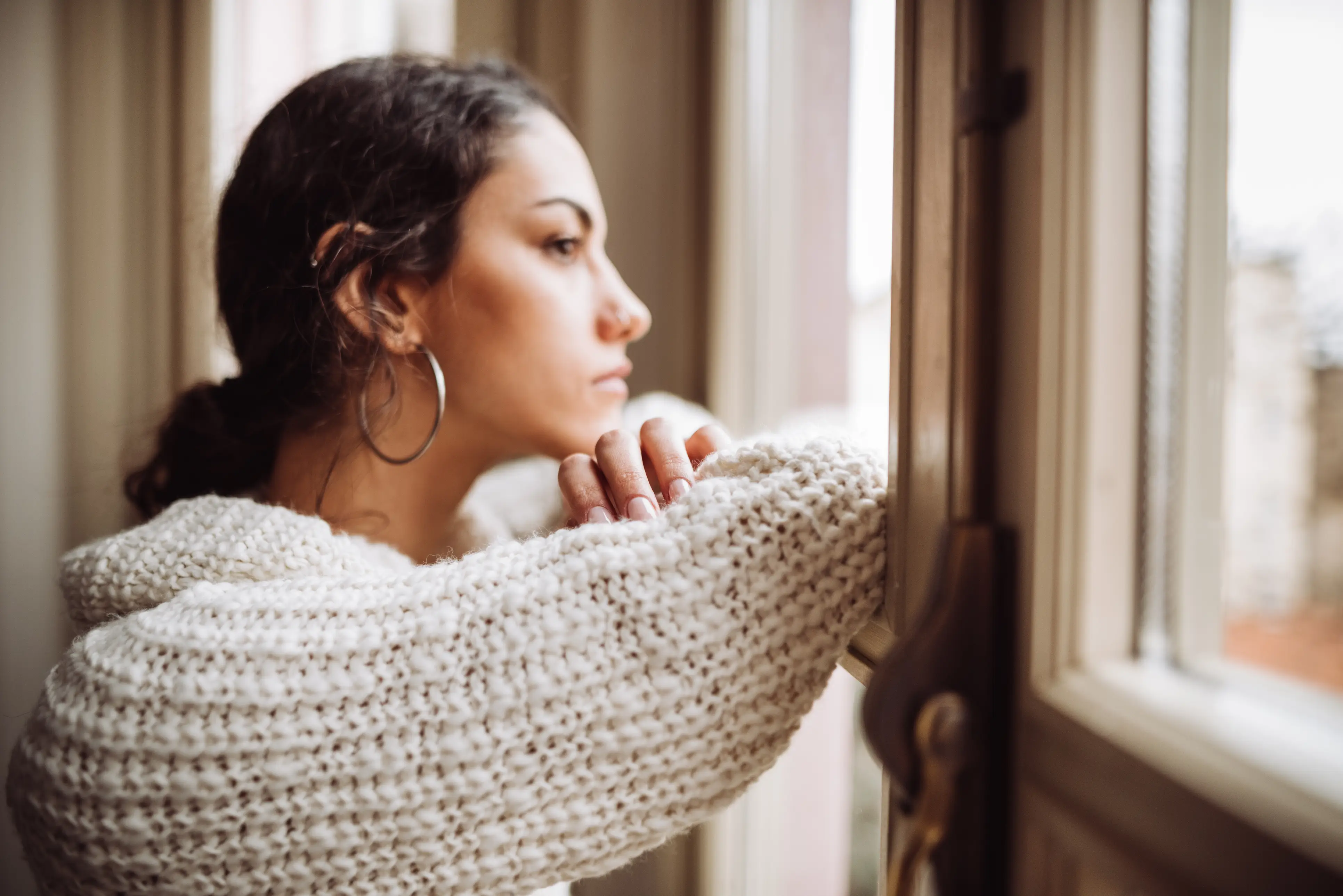 a woman looking out a window