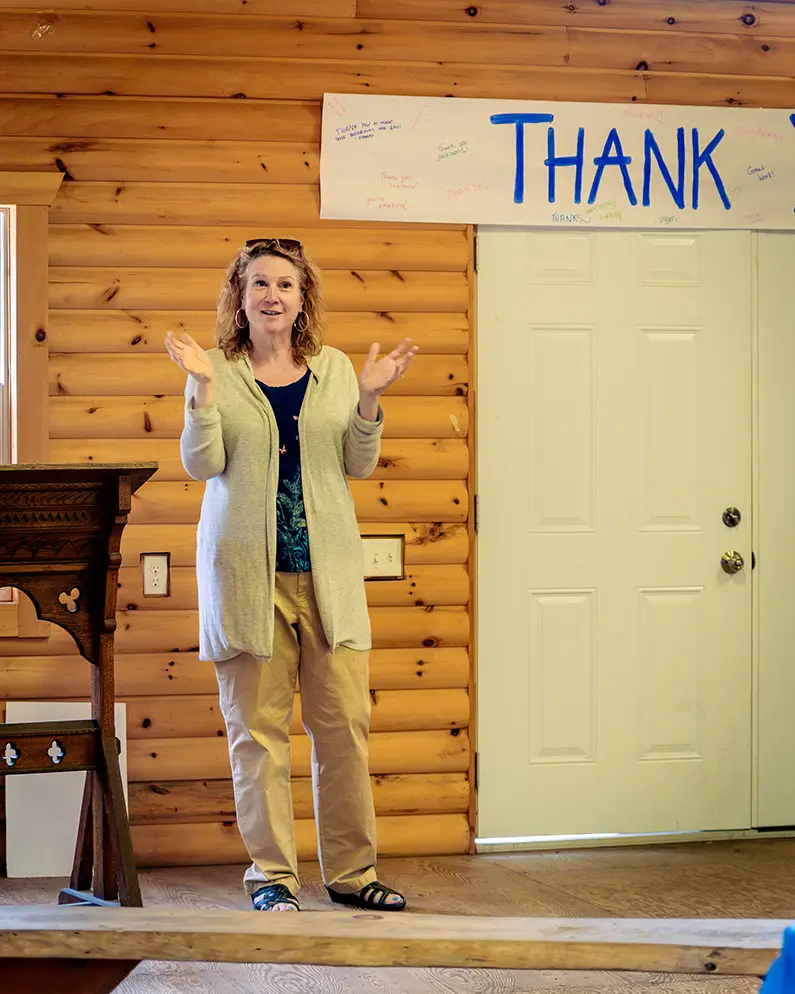 a woman standing in front of a sign