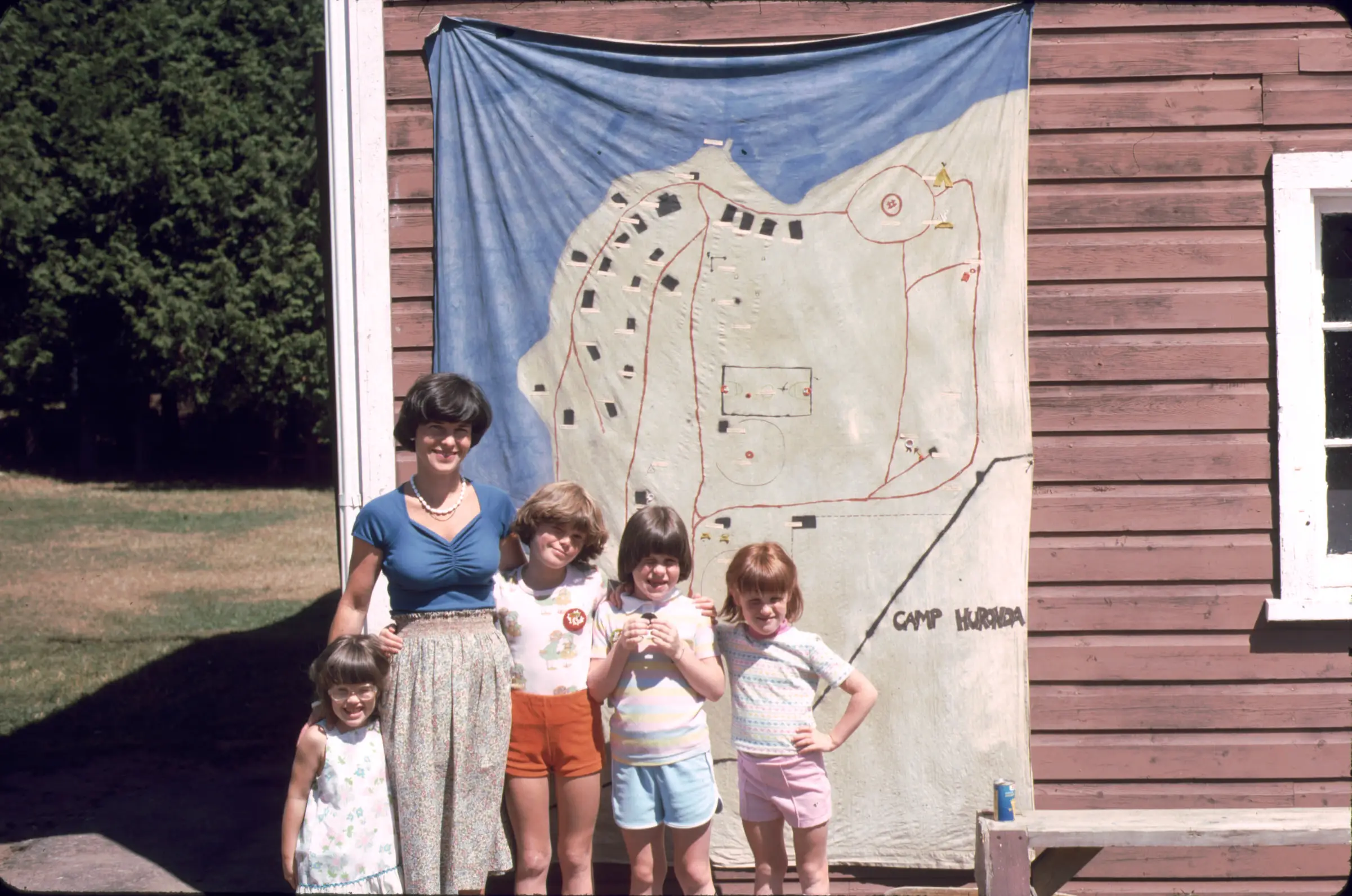 a group of children standing in front of a map