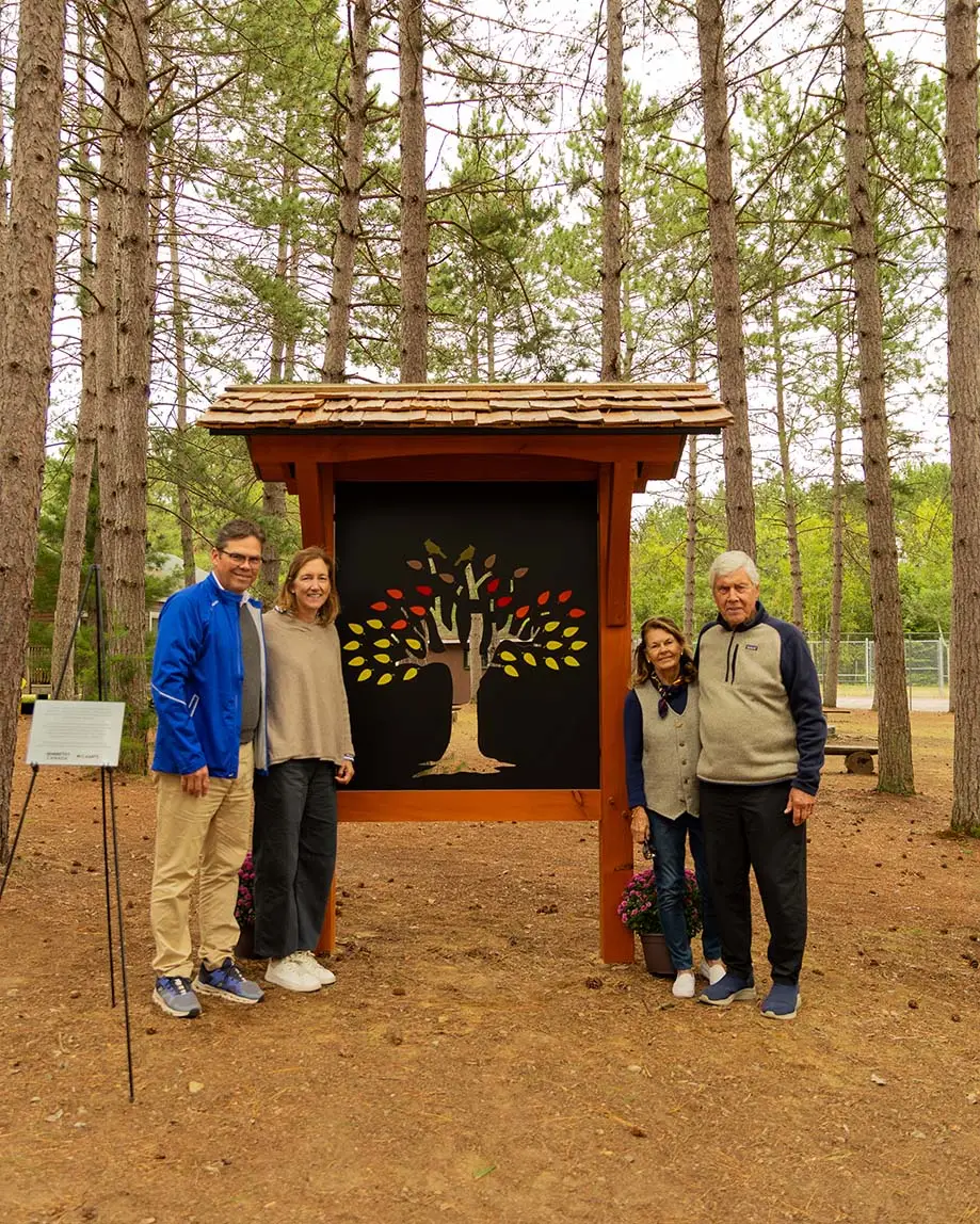 a group of people standing in front of a sign