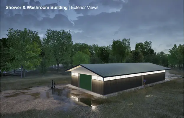 a building with a green door and a puddle of water