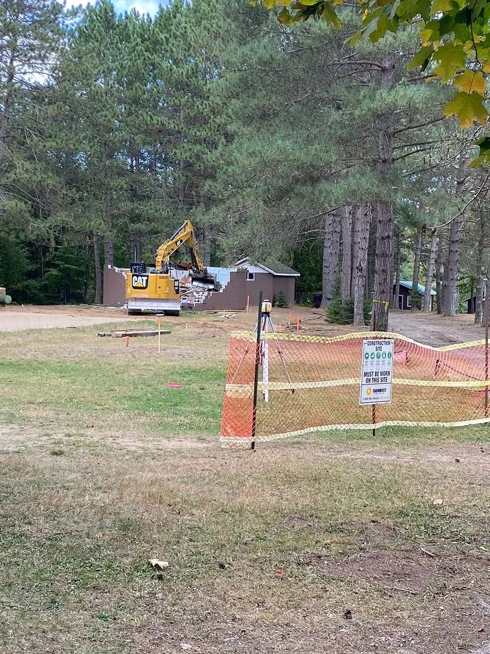 a construction site with a yellow excavator