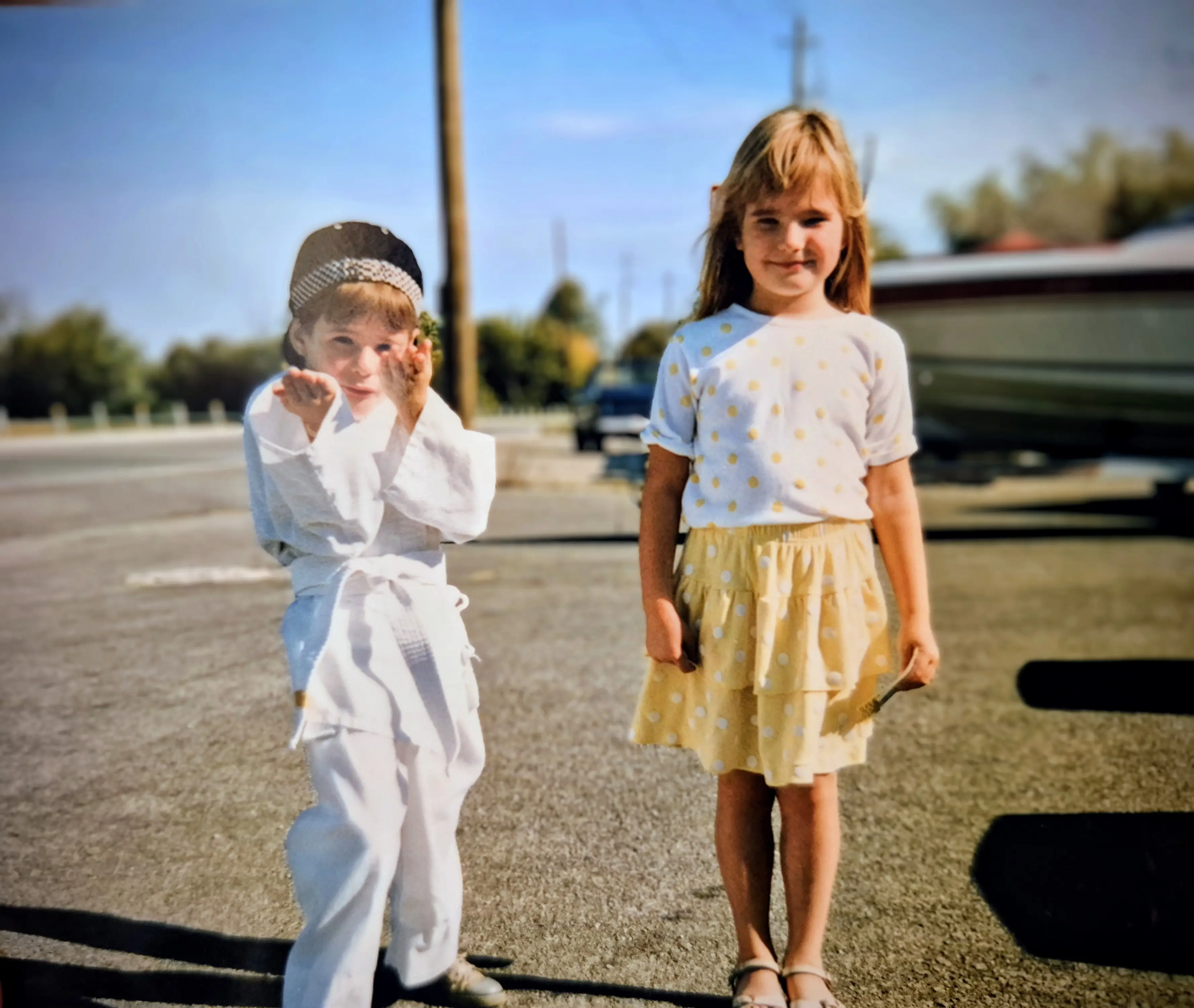 two girls standing in a parking lot