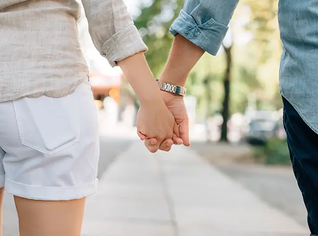a man and woman holding hands