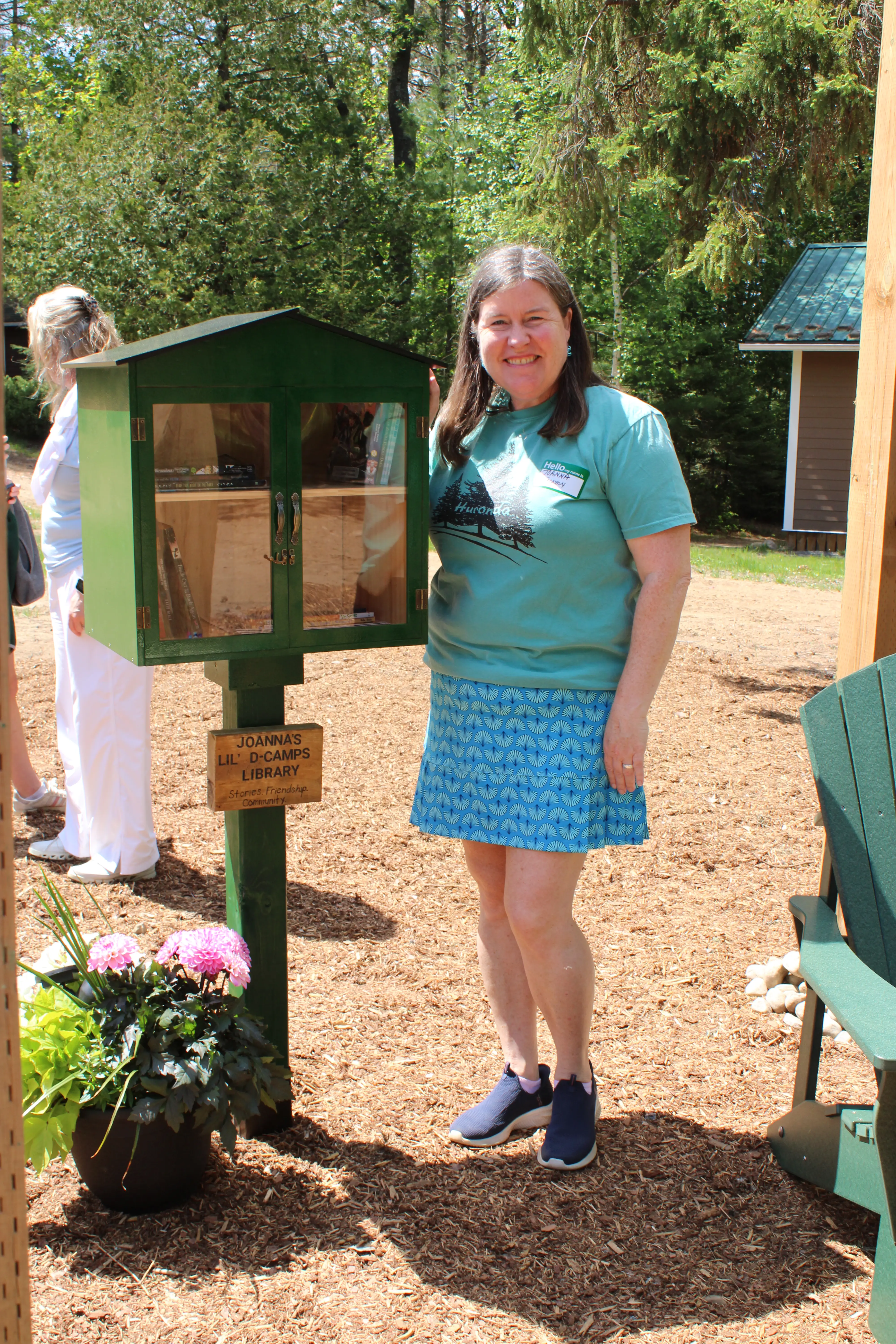 a woman standing next to a library